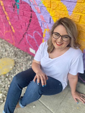 Blair sitting in front of a colorful mural